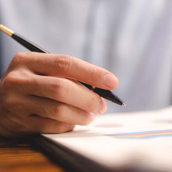 business-man-using-a-pen-to-sign-a-agreement-docum-XWNJA3L.jpg